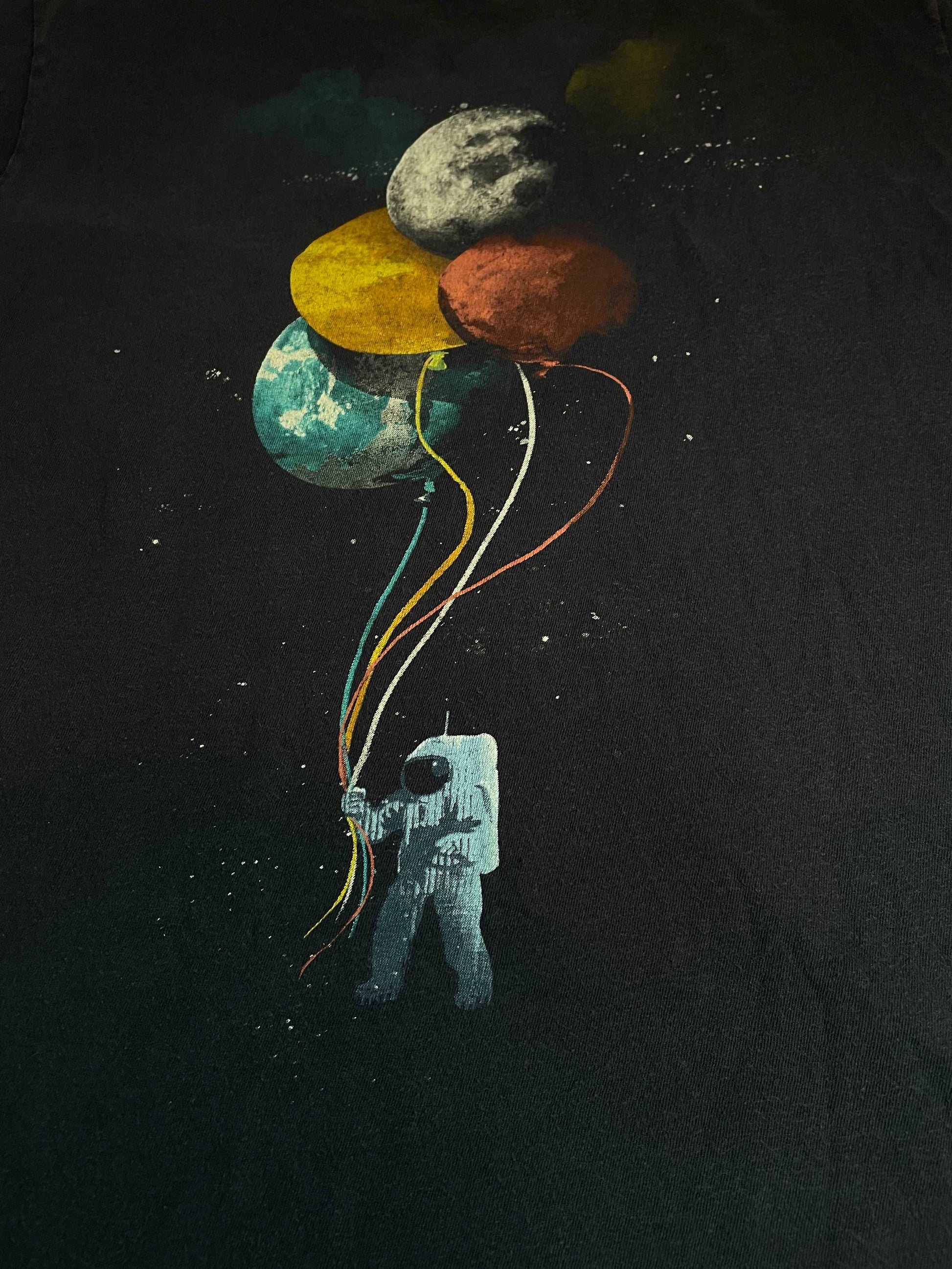 Astronaut Holding Planets